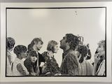 black and white photograph of a group of people standing in a line