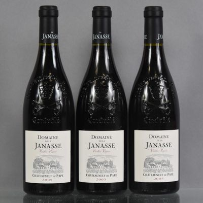 three bottles of red wine sitting on top of a table