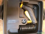 a black box with a yellow and black hose and a black and yellow hose