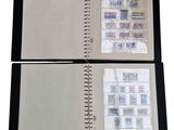 two pages of a book with stamps on them on a white surface