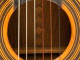 a close up of a guitar with strings and a wooden case
