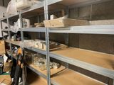 many shelves with boxes and containers on them in a room