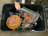 a person that is putting a pie in a trash can