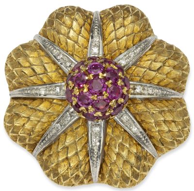 a gold and diamond flower broochle, by van cleef