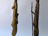 two bronze statues of a man and woman standing next to each other