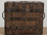 an old wooden box with a handle on a table