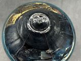 an image of a glass bottle with a hole in it