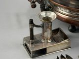 a silver plate with spoons and spoon rest on it