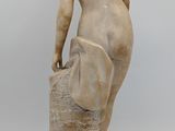 an image of a statue of a man standing on top of a rock