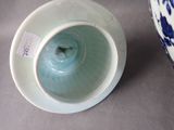 a blue and white vase with a tag on it