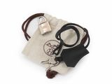 a small bag with a key and a keychain on it