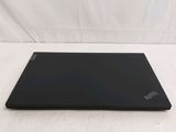 the back of a black laptop computer sitting on top of a white surface