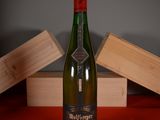 a bottle of wine sitting on a table next to a wooden box