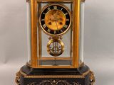 a black and gold clock on a white background