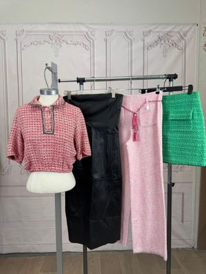 a mannequin in front of a display of clothes