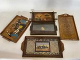 quatre plateaux en bois ornés d'images, posés sur une table