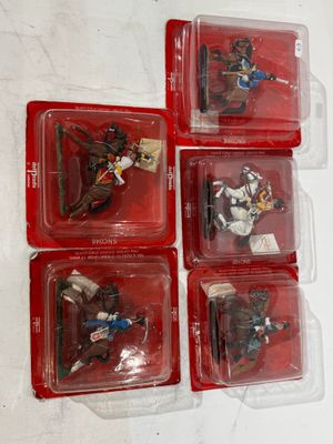 six plastic toy figures of a man riding a horse in a box