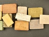 several different colored blocks of soap sitting on top of a table