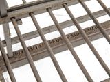 a close up of a metal grate on a white surface