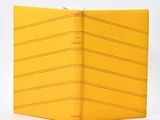 the yellow book is open on a white surface