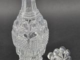 a glass vase and a small glass flower on the table
