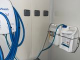 a blue hose attached to a white wall in a room