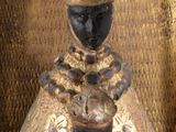 a statue of a woman with a hat on top of her head
