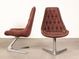 pair of mid - century modern lounge chairs with tufted upholstered seats