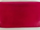 un sac à main rose avec une fermeture éclair à l'intérieur