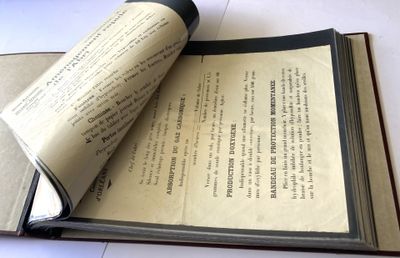 an open book on a table with a roll of paper on it