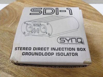 the box is open on a wooden table with a black and white logo