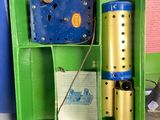 a green box with a blue and yellow object inside of it
