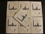 six white cards with black writing on them sitting on a table