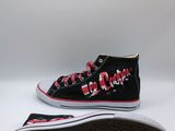 a close up of a pair of black and red sneakers