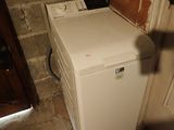 a washing machine in the corner of a room