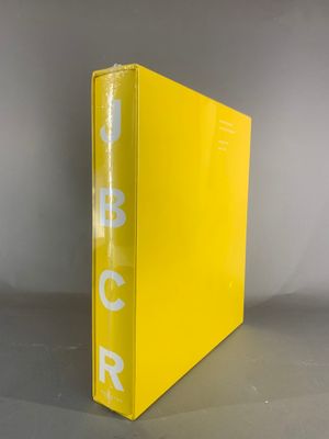 a close up of a yellow binder with a white logo on it
