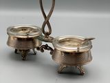 a pair of silverplated dishes with handles and handles