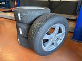 three tires stacked on top of each other in a garage