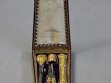 a box with a pair of scissors inside of it