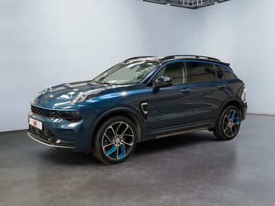 the blue suv is parked in a large room with white walls