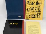 three books on a white surface with a black and yellow cover