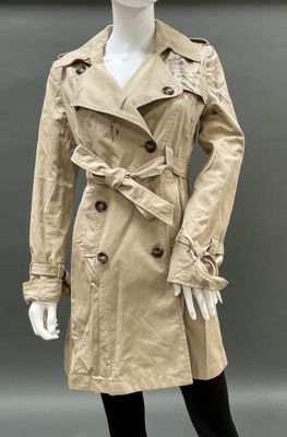 an image of a mannequin wearing a beige trench coat and black tights