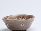 small bowl with holes in it on a white surface