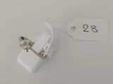 a small white object with a gold ring on it