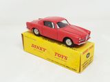 a red toy car sitting on top of a yellow box