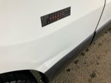 a sticker on the side of a white car