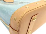 a close up of a blue and tan suitcase