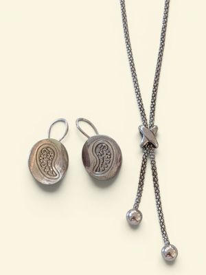 necklace and earring set with silver beads on a white background