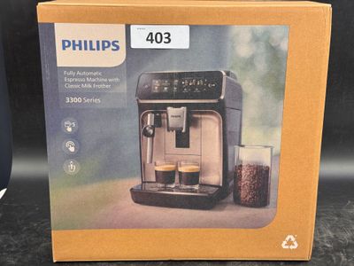 packaging of a coffee machine with a glass of water in front of it
