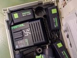 a box with a cordless drill and a battery in it